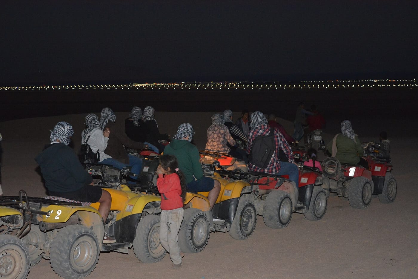 Quad bikes and a desert buggy lined up on golden Sinai dunes at sunset near Sharm El Sheikh